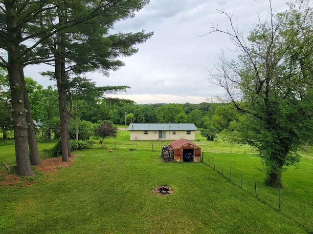 view of yard with an outbuilding and a rural view