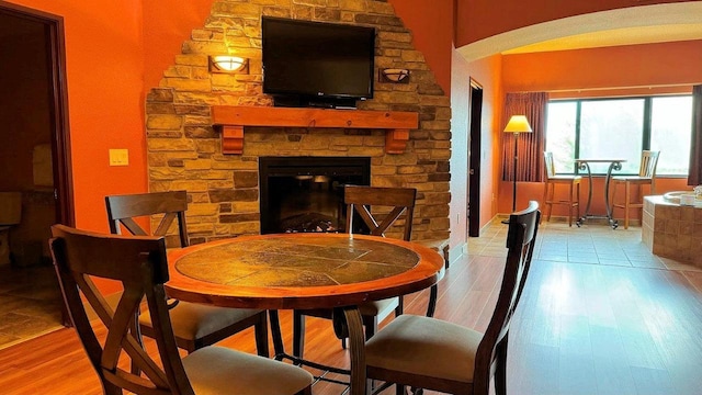 dining space with a fireplace and light hardwood / wood-style floors