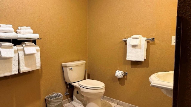 bathroom with tile patterned floors and toilet