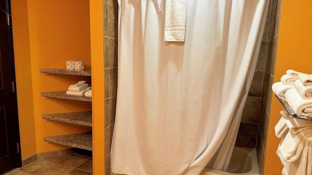 bathroom featuring tile patterned flooring and a shower with shower curtain