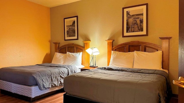 bedroom with wood-type flooring