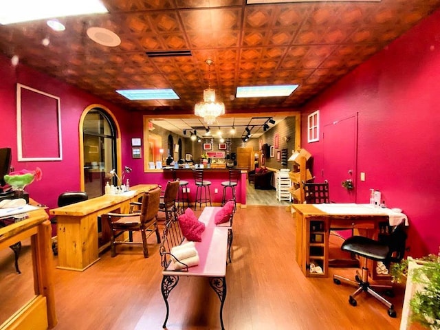 interior space with rail lighting and wood-type flooring