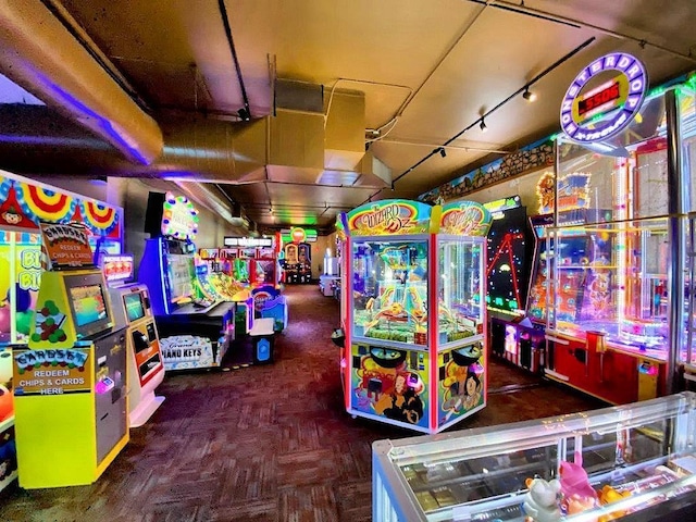 game room featuring dark parquet flooring and rail lighting