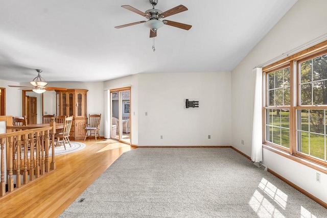 living room featuring ceiling fan and light hardwood / wood-style floors