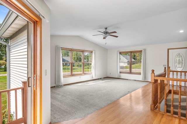 living room with light hardwood / wood-style floors, a wealth of natural light, lofted ceiling, and ceiling fan