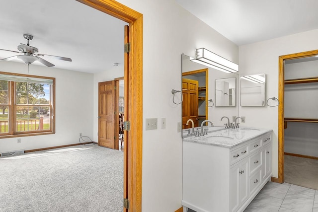 bathroom with ceiling fan and vanity