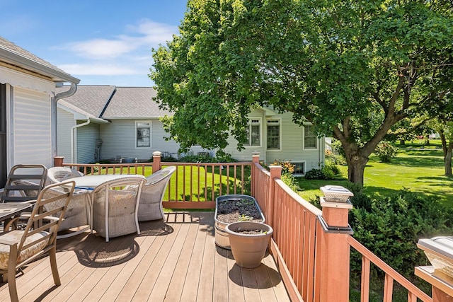 wooden terrace featuring a yard