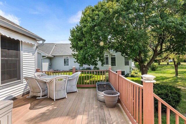 wooden deck with a lawn