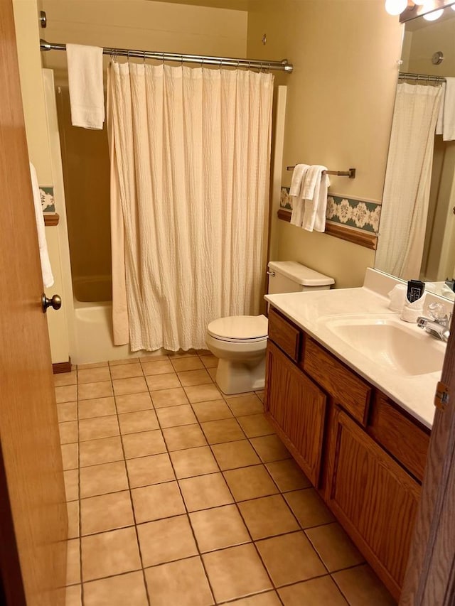 full bathroom featuring tile patterned floors, vanity, shower / bath combination with curtain, and toilet