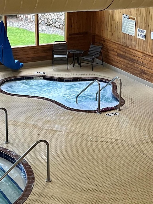 view of swimming pool with an indoor hot tub