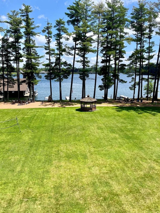 view of home's community with a gazebo, a lawn, and a water view