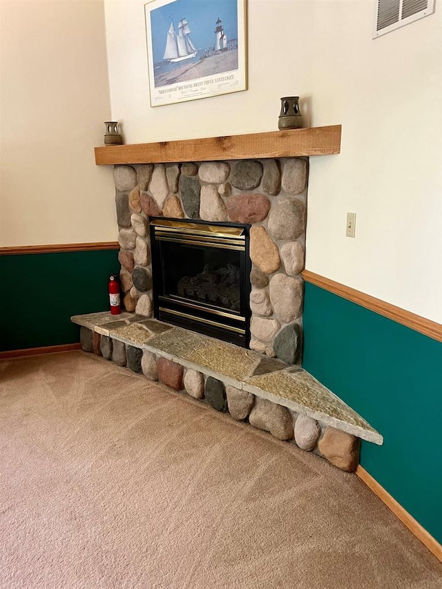 room details featuring carpet and a fireplace