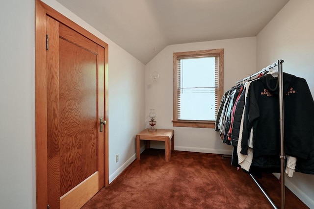 spacious closet featuring vaulted ceiling and dark carpet