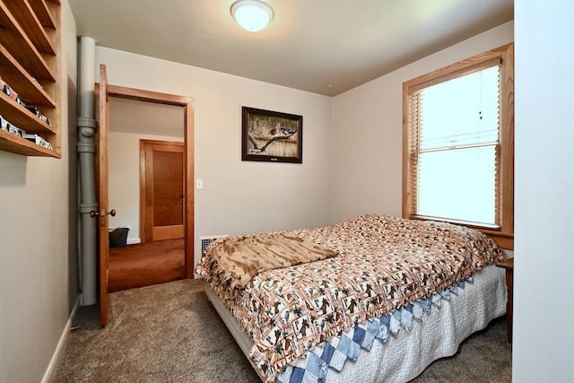 carpeted bedroom featuring baseboards