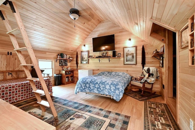 bedroom featuring lofted ceiling, wooden walls, wood finished floors, and wooden ceiling