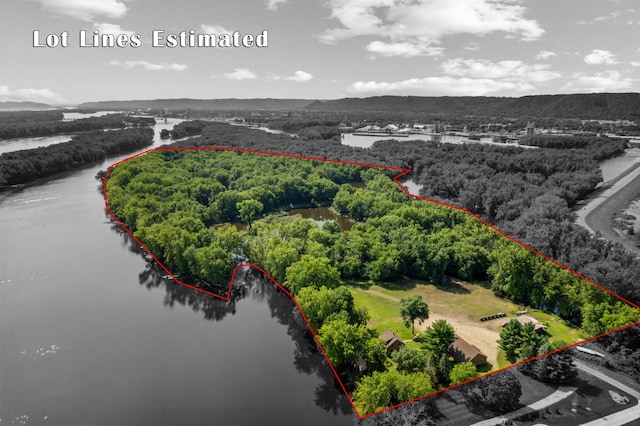 aerial view featuring a forest view and a water view