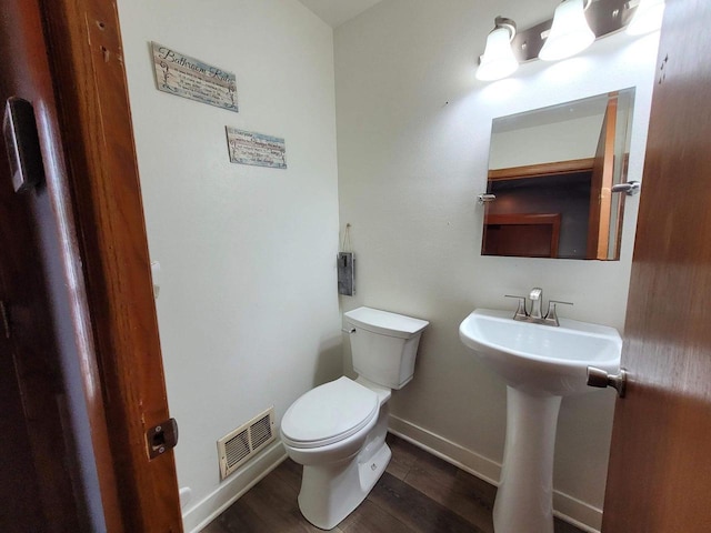 bathroom with hardwood / wood-style flooring, sink, and toilet