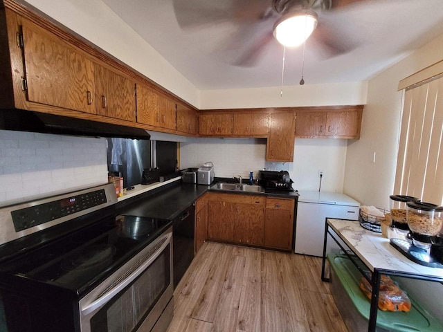 kitchen with backsplash, stainless steel electric stove, sink, light wood-type flooring, and black dishwasher