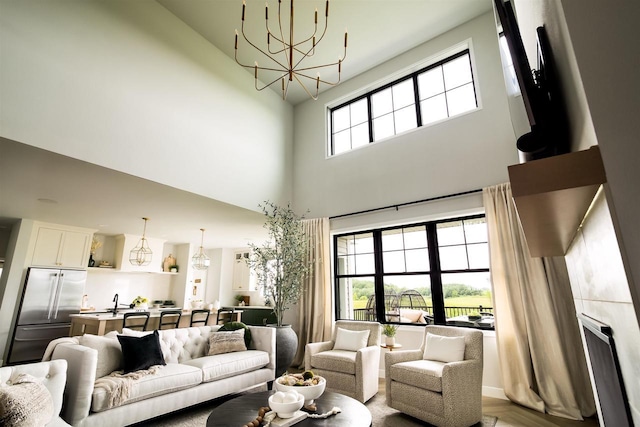 living room with a high ceiling and a notable chandelier