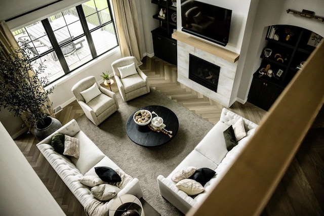 living room featuring parquet flooring and a high end fireplace