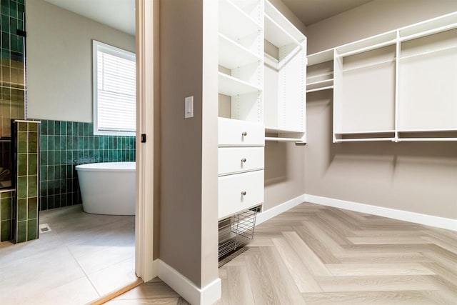 spacious closet featuring light parquet flooring