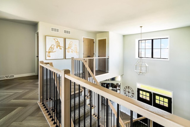 hall featuring a chandelier and dark parquet floors