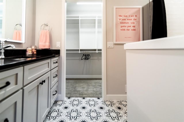 bathroom with tile patterned floors and vanity