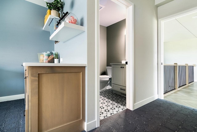 bathroom featuring vanity and toilet