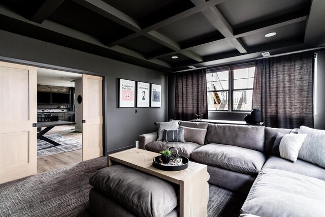 cinema room with beamed ceiling, wood-type flooring, and coffered ceiling