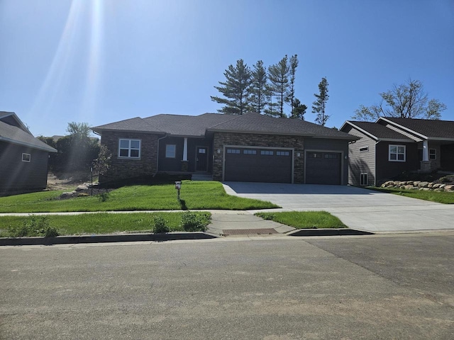 single story home featuring a front yard, an attached garage, and concrete driveway