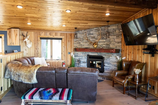 living room featuring hardwood / wood-style flooring, wooden ceiling, and wood walls