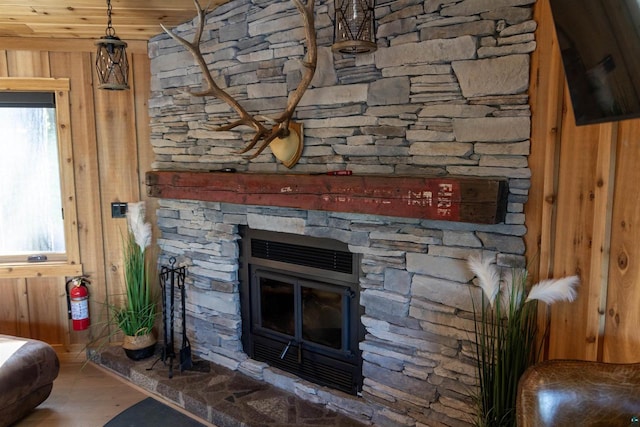 room details with wooden walls, a fireplace, and wood-type flooring