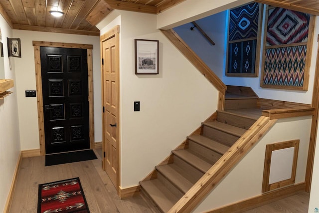 foyer with wooden ceiling and light hardwood / wood-style flooring