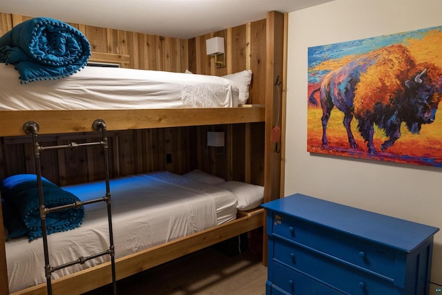 bedroom with wood walls