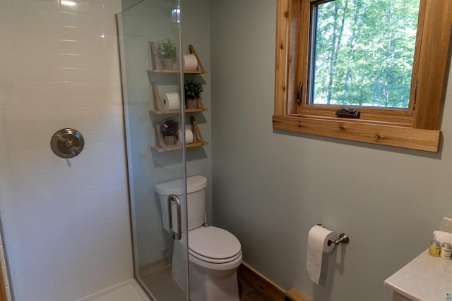 bathroom with walk in shower, plenty of natural light, and toilet