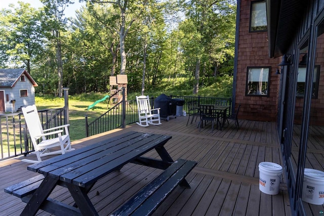 wooden terrace with a playground