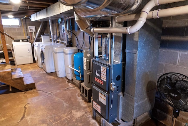 utility room with independent washer and dryer and heating unit