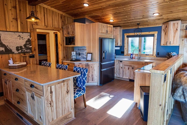 kitchen featuring sink, hanging light fixtures, wooden counters, dark hardwood / wood-style floors, and black appliances