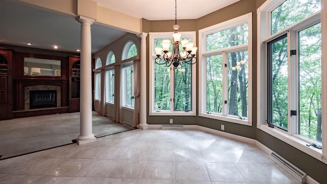 unfurnished dining area featuring ornate columns, a baseboard radiator, light tile patterned floors, and a notable chandelier