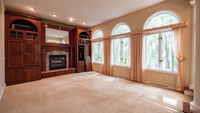 unfurnished living room featuring light carpet and ornate columns