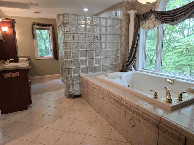 bathroom with tile patterned floors, shower with separate bathtub, and vanity