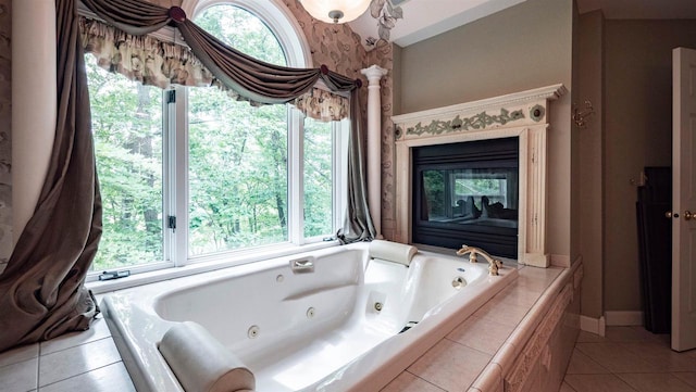 bathroom featuring tile patterned flooring and a relaxing tiled tub