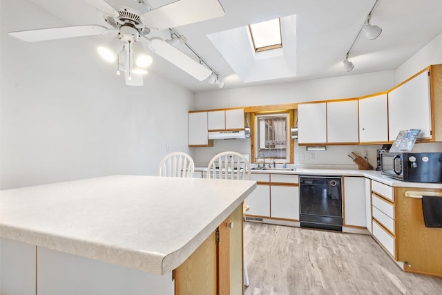 kitchen with black appliances, light hardwood / wood-style flooring, a skylight, ceiling fan, and white cabinetry