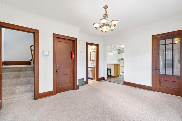 interior space featuring ornamental molding, carpet floors, and a chandelier