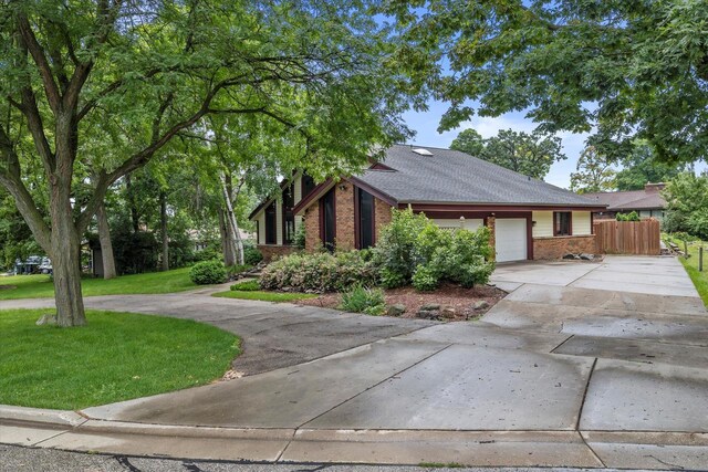 view of front of home featuring a front yard and a garage