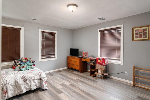 bedroom with light hardwood / wood-style floors