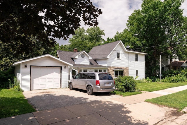 view of front of property with a front lawn, an outdoor structure, and a garage