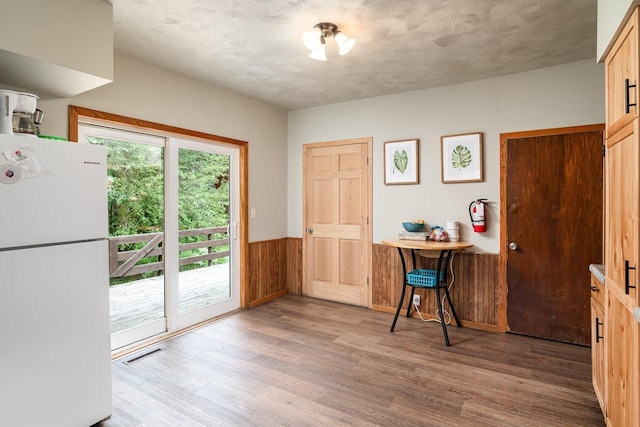 interior space featuring wood walls and light hardwood / wood-style floors