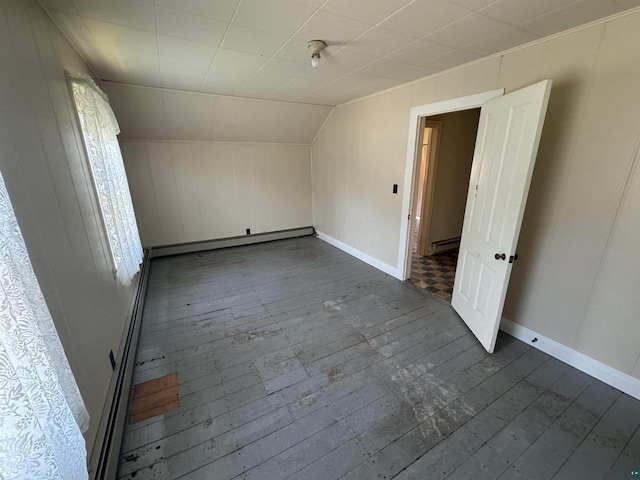 bonus room with lofted ceiling, baseboard heating, and dark wood-type flooring