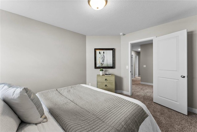 bedroom featuring a textured ceiling and carpet floors